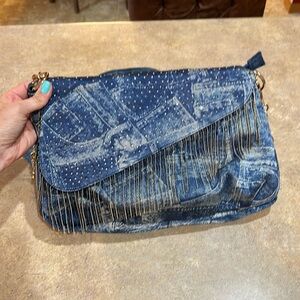 Womens purse it looks like denim but its not it has rhinestones and chain fringe